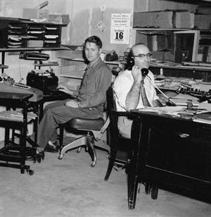 Leonard J. Lichtenstein on the phone in a 1960s office, with a colleague at the desk