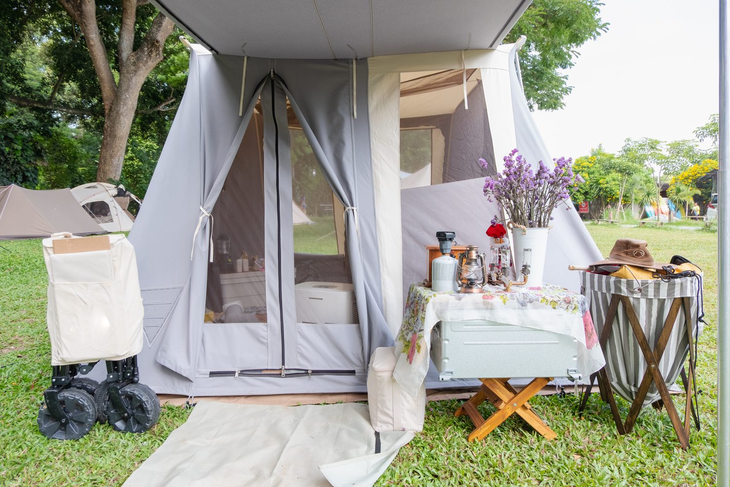 Outdoor tent campsite with zippered fabric shelter entrance