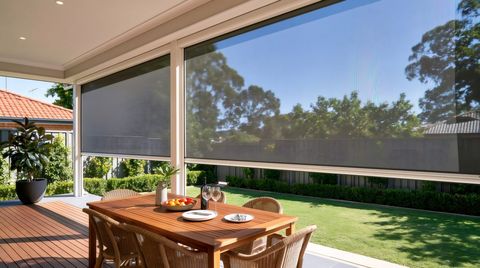 Dining patio with retractable mesh screens overlooking a backyard