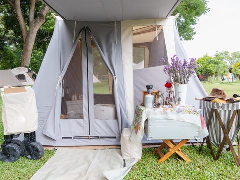 Outdoor tent campsite with zippered fabric shelter entrance