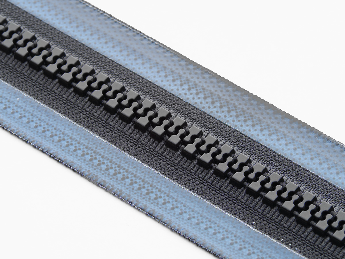 Close-up of black weldable zipper chain with coated tape