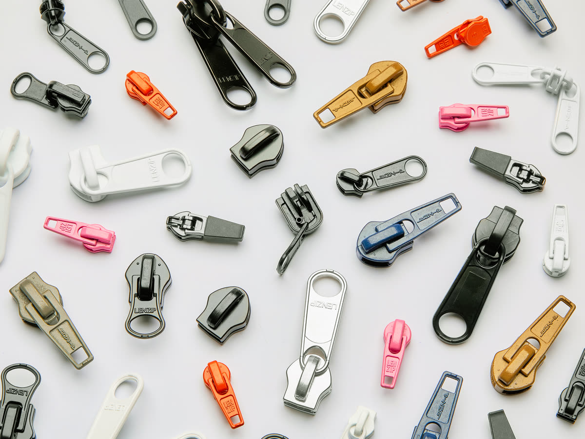 Assortment of Lenzip zipper sliders and pulls in metal and plastic finishes